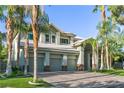 Charming curb appeal with mature palm trees and green grass surrounding this home at 2309 Prometheus Ct, Henderson, NV 89074