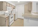 Well-lit kitchen featuring ample cabinet space and modern white appliances at 231 W Horizon Ridge Pkwy # 527, Henderson, NV 89012