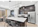 Modern kitchen featuring stainless steel appliances, a quartz countertop island and an adjacent dining area at 2536 Catallo St, Henderson, NV 89044