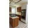 Galley style kitchen with tile floors and stainless steel oven at 2711 Seabridge Dr, Las Vegas, NV 89121