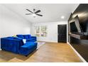 Bright living room features hardwood floors, a large sectional sofa, and ample natural light through large windows at 2913 Bradford Hill Ave, North Las Vegas, NV 89031