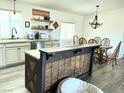 Bright dining area featuring a kitchen island, wooden table, and hardwood floors at 325 Ron Ave, Logandale, NV 89021