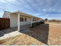 Exterior view of a home featuring a covered side patio and clean landscaping at 325 Ron Ave, Logandale, NV 89021