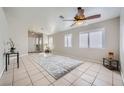 Inviting living room with tile floor, bright windows, and neutral paint scheme at 3531 Barrel Bronco Ct, North Las Vegas, NV 89032