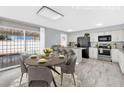 Staged kitchen and dining area with a granite countertops and modern black appliances at 3800 San Joaquin Ave, Las Vegas, NV 89102