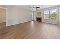 Spacious living room featuring light wood floors, a fireplace, and a large window for natural light at 5855 Valley Dr # 2170, North Las Vegas, NV 89031