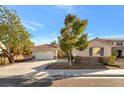 Well-maintained single-Gathering home with a spacious driveway, two-car garage, and drought-tolerant landscaping at 5873 Wildhorse Ledge Ave, Las Vegas, NV 89131