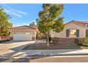 Charming single-story home with a well-manicured lawn, two-car garage, and desert landscaping at 5873 Wildhorse Ledge Ave, Las Vegas, NV 89131