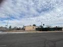 Street-level view of the house showcasing its exterior, surrounding fence, and neighborhood setting at 609 Kasper Ave, Las Vegas, NV 89106