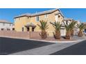 View of the side of the house, with a brick wall and trees at 6430 Jackrabbit Run Ave, Las Vegas, NV 89122