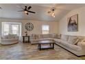 Cozy living room features large windows and a comfortable sectional sofa at 6917 Leon Ave, Las Vegas, NV 89131