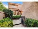 Inviting courtyard showcasing well-maintained landscaping, a secure gate, and partial views of the house at 7607 Boca Raton Dr, Las Vegas, NV 89113