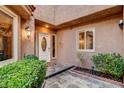 Covered front porch with tiled flooring, updated exterior lighting, and a decorative glass front door at 7607 Boca Raton Dr, Las Vegas, NV 89113