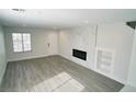 Contemporary living area with sleek hardwood floors, modern fireplace, and ample natural light at 7808 Wavering Pine Dr, Las Vegas, NV 89143