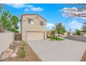 View of the two-story home and attached two car garage with extended driveway at 8324 Shark Tank Ct, Las Vegas, NV 89128