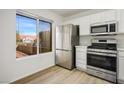 Cozy kitchen with stainless steel refrigerator, ample counter space and a bright window at 9001 Marble Dr, Las Vegas, NV 89134