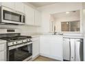 Bright kitchen featuring white cabinetry, stainless steel appliances, and modern fixtures at 9001 Marble Dr, Las Vegas, NV 89134