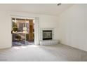 Spacious carpeted living room with fireplace and sliding glass doors to the backyard at 9001 Marble Dr, Las Vegas, NV 89134