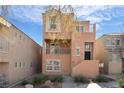 Stylish three-story home showcasing stucco facade, charming balconies, and curb appeal at 9124 Palatial Palette Ct, Las Vegas, NV 89149