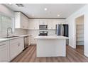 Modern kitchen with stainless steel appliances, white cabinets, and center island at 9124 Palatial Palette Ct, Las Vegas, NV 89149