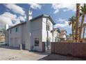 Exterior view of a home featuring a two-car garage and a terra cotta tiled roof at 924 Angel Star Ln, Las Vegas, NV 89145