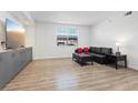 Modern living room with sleek flooring, recessed lighting, and a stylish entertainment center at 10225 King Henry Ave # 102, Las Vegas, NV 89144