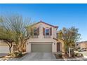 Charming two-story home with a well-manicured front yard and a two-car garage at 10655 Tray Mountain Ave, Las Vegas, NV 89166