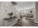 Inviting living room features a staircase, hardwood floors, and natural light at 10655 Tray Mountain Ave, Las Vegas, NV 89166