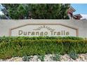 Stone community sign that reads Durango Trails with bushes and small rocks around the sign at 1153 Dusty Creek St, Las Vegas, NV 89128