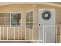 Close up of front door with a decorative wreath and a small gated porch area at 1153 Dusty Creek St, Las Vegas, NV 89128