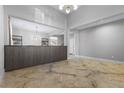 Spacious living room featuring modern built-in cabinetry, marble-look flooring, and ample natural light at 12135 Kite Hill Ln, Las Vegas, NV 89138