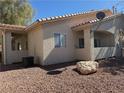 Tan home exterior with terracotta roof, desert landscaping, and satellite dish at 1881 W Alexander Rd # 1035, North Las Vegas, NV 89032