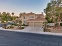 Two-story home with desert landscaping, a two-car garage, and a red tile roof at 1921 Spyglass Dr, Henderson, NV 89074