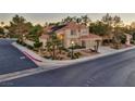 A two-story house with desert landscaping, a two-car garage, and a red tile roof at 1921 Spyglass Dr, Henderson, NV 89074