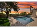 Inviting swimming pool and spa area with lush landscaping, perfect for outdoor relaxation and entertainment at 2690 Grassy Spring Pl, Las Vegas, NV 89135