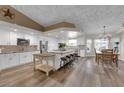 Spacious kitchen with white cabinets, stainless steel appliances, large island and adjoining dining area at 2901 S Dandelion St, Pahrump, NV 89048