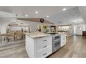 Open-concept kitchen with granite island, cooktop, and plenty of space for entertaining at 2901 S Dandelion St, Pahrump, NV 89048