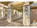 Inviting front entrance with a secure gate and neutral color palette at 310 Silva Pl, Henderson, NV 89011