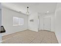 Bright, neutrally decorated dining room with tile flooring and modern light fixture at 376 Shanon Springs St, Henderson, NV 89014