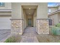 Inviting front porch with stone accents and a paved walkway leading to the front door at 376 Shanon Springs St, Henderson, NV 89014