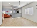 Open concept living area with tile flooring, modern decor, and plenty of natural light at 376 Shanon Springs St, Henderson, NV 89014