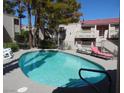 Sparkling community pool with lounge chairs surrounded by mature trees at 3781 Desert Marina Dr # 101, Laughlin, NV 89029