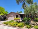 Charming home with mature landscaping, including vibrant yellow flowers at 5050 Grandview Dr, Las Vegas, NV 89120