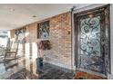 Elegant entryway featuring brick wall with decorative ironwork and an ornate glass-paneled front door at 5162 Woodruff Pl, Las Vegas, NV 89120