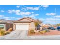 Lovely single-story home with a two-car garage, desert landscaping, tile roof, and a paved driveway at 6061 Leaping Foal St, North Las Vegas, NV 89081
