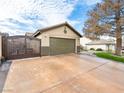 Attached garage with a private gate and driveway at 6627 Bristle Canyon Ave, Las Vegas, NV 89110