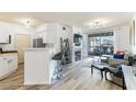 Bright living room with fireplace, bar seating, and sliding glass doors to a balcony at 7115 S Durango Dr # 308, Las Vegas, NV 89113