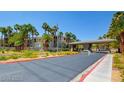 Inviting community entrance with palm trees and an American flag waving in the breeze at 7115 S Durango Dr # 313, Las Vegas, NV 89113
