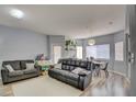 Bright living room features modern furnishings, wood-look floors, and plenty of space for relaxation and entertainment at 833 Aspen Peak Loop # 712, Henderson, NV 89011