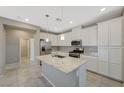 Bright kitchen with granite counters, stainless steel appliances and tile floors at 8562 Insignia Ave # 102, Las Vegas, NV 89178